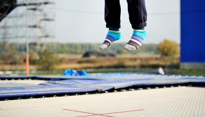 picture of boy jumping on trampoline