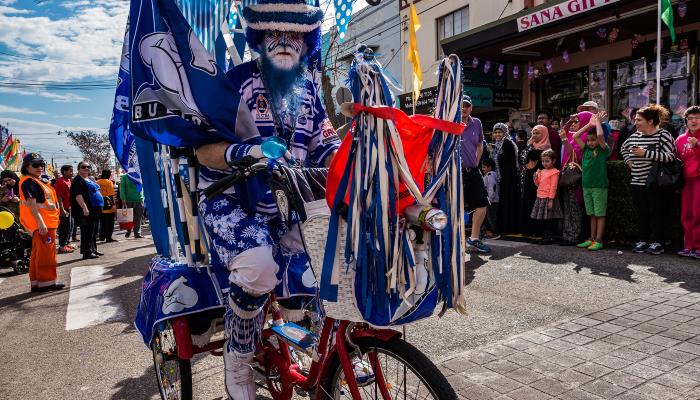 man in costume riding a bike